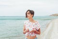 Beautiful woman relax during exotic vacation on the beach enjoying sweet coffee Royalty Free Stock Photo