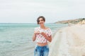 Beautiful woman relax during exotic vacation on the beach enjoying sweet coffee Royalty Free Stock Photo