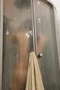 Beautiful woman in the shower behind glass with drops. woman in the shower behind glass with drops. vertical photo Royalty Free Stock Photo