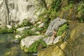 Beautiful woman is showering in the hidden waterfalls of Serik region in Antalya