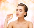 Beautiful woman showing bottle with golden dust Royalty Free Stock Photo