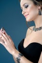 Beautiful woman showing earrings necklace and ring on blue dark Royalty Free Stock Photo