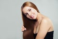 Beautiful woman showing her long perfect healthy brown hair on white background. Cute girl with straight hairstyle, haircare Royalty Free Stock Photo