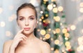 Beautiful woman showing lips over christmas lights Royalty Free Stock Photo