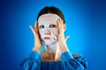 Woman shows how to apply a beauty mask to your face Royalty Free Stock Photo