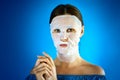 Woman shows how to apply a beauty mask to your face Royalty Free Stock Photo
