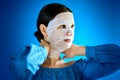 Woman shows how to apply a beauty mask to your face Royalty Free Stock Photo