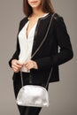 Beautiful woman with a silver fashion bag