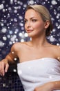 Beautiful woman sitting in bath towel at sauna Royalty Free Stock Photo