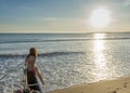 Beautiful woman sitting at the boat on the beach Royalty Free Stock Photo