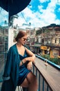 Beautiful woman sitting on cafe terrace. Panoramic street view of Da Lat city, little Paris of Vietnam Royalty Free Stock Photo