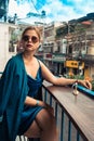 Beautiful woman sitting on cafe terrace. Panoramic street view of Da Lat city, little Paris of Vietnam Royalty Free Stock Photo