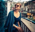 Beautiful woman sitting on cafe terrace. Panoramic street view of Da Lat city, little Paris of Vietnam