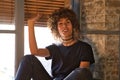 Beautiful woman sitting on the edge of a large window in her studio while making different expressions of joy and depression. Royalty Free Stock Photo