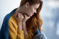 beautiful woman sitting near the window with a blue plaid dreamy look Royalty Free Stock Photo