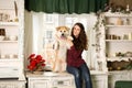 Beautiful woman sitting retro tree dresser. hugs, cuddles with her akita inu dog Royalty Free Stock Photo