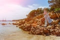 Beautiful woman sitting on a rock ocean shore Royalty Free Stock Photo