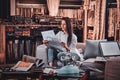 Beautiful woman is sitting on the sofa at her curtians studio Royalty Free Stock Photo