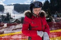 Beautiful woman in ski suit, with helmet and ski goggles putting Royalty Free Stock Photo