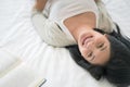 Beautiful woman sleeping on the bed sleeping after reading a book overnight Royalty Free Stock Photo