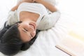 Beautiful woman sleeping on the bed sleeping after reading a book overnight Royalty Free Stock Photo