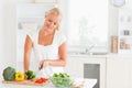 Beautiful woman slicing pepper