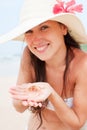 Beautiful woman with small crab in her palms