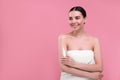 Beautiful woman with smear of body cream on her arm against pink background, space for text Royalty Free Stock Photo