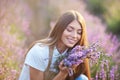 Beautiful woman smelling bouquet scent in lavender field. Royalty Free Stock Photo
