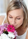Beautiful woman smelling a bunch of flowers Royalty Free Stock Photo