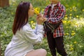 Beautiful woman smelling dandelions from her son in park. Kid bringing flowers to mother. Royalty Free Stock Photo