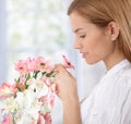 Beautiful woman smelling flowers Royalty Free Stock Photo