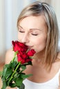 Beautiful woman smelling roses Royalty Free Stock Photo