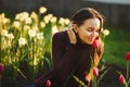 Beautiful woman smelling the tulips planted. Royalty Free Stock Photo