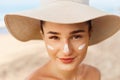 Beautiful Woman smile applying sun cream on face. Skin and  Body  care. Sun protection. Royalty Free Stock Photo