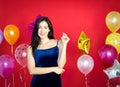 A beautiful woman is smiling behind a balloon on a red background.,happy New Year,Merry Christmas