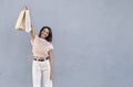 beautiful woman smiling at camera and pointing to shopping bag with white copy space, advertising area for text or image. indoor Royalty Free Stock Photo