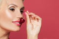 Beautiful woman smiling closeup, smile with white teeth and red cherry berry in her hand Royalty Free Stock Photo