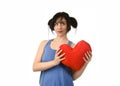 Beautiful woman smiling happy feeling in love holding red heart shape pillow Royalty Free Stock Photo