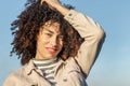 Beautiful woman smiling and touching her afro hair