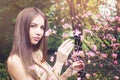 Beautiful woman sniffing flowers outdoors Royalty Free Stock Photo