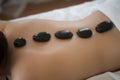 Beautiful woman spa hot stone massage beauty