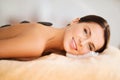 Beautiful woman in spa salon with hot stones Royalty Free Stock Photo