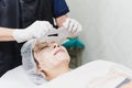 Beautiful woman in the spa salon, Treatment hyperpigmentation and melasma on face by serum mask. Royalty Free Stock Photo