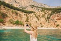 Beautiful woman on speed boat driving to paradise beach island taking photo smart phone discover summer adventure Royalty Free Stock Photo