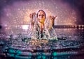 Beautiful woman splashing water in swimming pool. Artist effect. Royalty Free Stock Photo