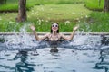 Beautiful woman splashing water in swimming pool Royalty Free Stock Photo