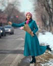 Beautiful woman with spring tulips flowers bouquet at city street. Royalty Free Stock Photo