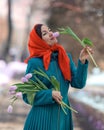 Beautiful woman with spring tulips flowers bouquet at city street. Happy portrait of girl smiling with pink tulip Royalty Free Stock Photo