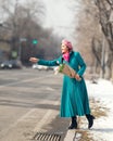 Beautiful woman with spring tulips flowers bouquet at city street. Happy portrait of girl smiling with pink tulip Royalty Free Stock Photo